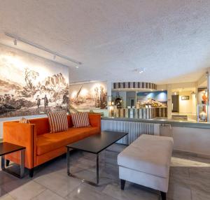 a living room with a couch and a table at Skala Hotel in Skala