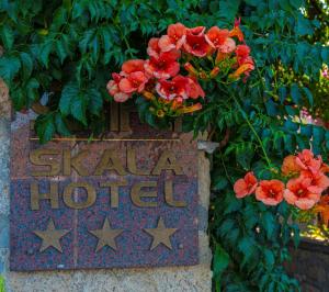 a sign for a star hotel with flowers on it at Skala Hotel in Skala