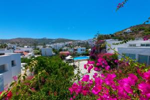 a view of a city with pink flowers at Skala Hotel in Skala