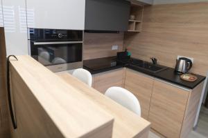 A kitchen or kitchenette at Manna Aparthotel