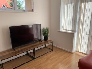 un soggiorno con TV a schermo piatto e tavolo di 2 Bed House Waterside Luxury Living, Central Area a Leicester