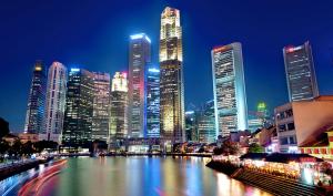 a city skyline at night with a river and buildings at K Space Inn 14 in Singapore