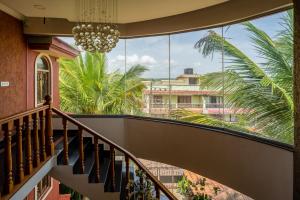 a view from the stairs of a house with a chandelier at Raposo Resorts in Vagator