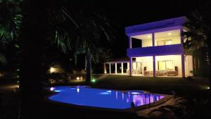 a house with a swimming pool at night at ALASHATO Alacati in Alaçatı