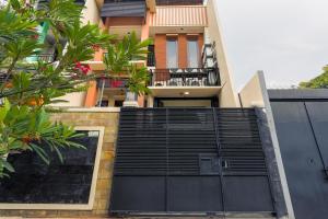 an external view of a house with a black garage door at SUPER OYO 3109 Point Inn in Jakarta