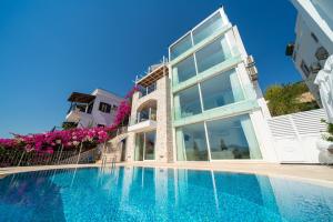 a house with a swimming pool next to a building at Buqqva Residence in Kalkan