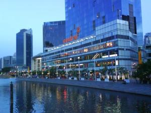 a building next to a river in a city at K Space Inn 14 in Singapore