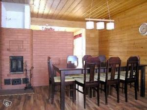 a dining room with a table and chairs and a fireplace at Cottage Elsa in Kuopio +20 photos