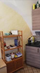 a shelf in a kitchen next to a counter at CORSINI HOUSES- CATANIA in Catania