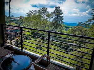 a balcony with a view of a forest at Surya Hotel & Resort in Baturaden