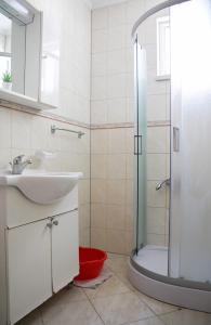 a bathroom with a sink and a shower at Apartments Jurković in Neum