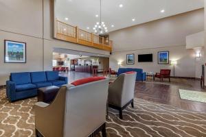 a lobby with couches and chairs and a staircase at Comfort Suites Delavan - Lake Geneva Area in Delavan