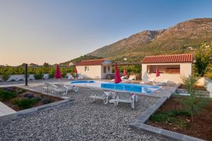 a backyard with a swimming pool and a house at Villa Liberty in Cavtat