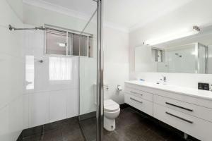 a bathroom with a toilet and a sink and a shower at Quality Inn Ashby House Tamworth in Tamworth