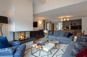 a living room with a couch and a fireplace at Thurnher's Residences in Zürs am Arlberg