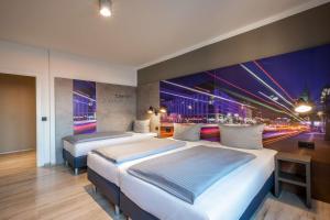 Comfort Hotel Lichtenberg tesisinde bir odada yatak veya yataklar