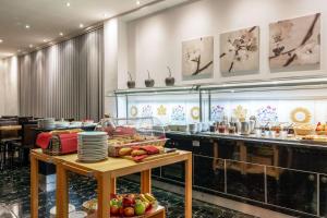 a buffet line in a restaurant with food on display at Comfort Hotel Atlantic Muenchen Sued in Ottobrunn