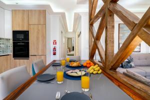 a dining room with a table with orange juice at WHome | Great Location & Large Family Apartment w/Patio in Lisbon