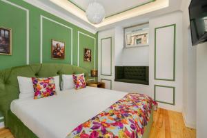 a bedroom with a white bed and green walls at WHome | Great Location & Large Family Apartment w/Patio in Lisbon