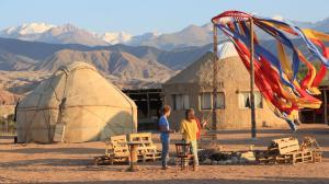 two people standing in front of a tent and a kite at Bel Tam in Tong