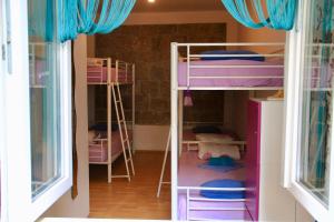 two bunk beds in a room with a window at Hostel Wonderful World in Split