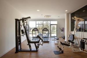 a gym with several tread machines in a room at The Classic Hotel in Nicosia