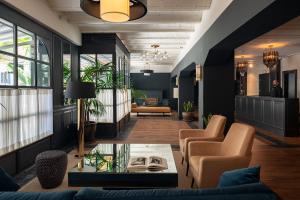 a lobby with chairs and a table in a room at La França Hotel Boutique in Barcelona