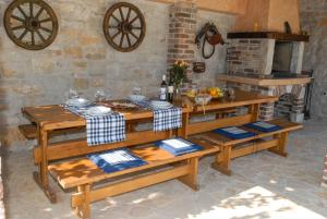 a kitchen with wooden tables and a stove at Villa Simone in Žbandaj