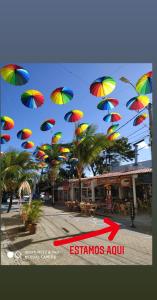 a bunch of colorful umbrellas flying in the air at Flats & Suites Cheiro do Mar in Porto De Galinhas
