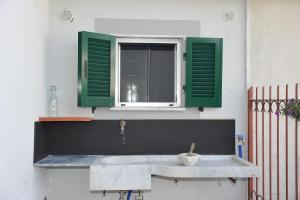 a kitchen sink with green shutters and a window at Casa del Menegotto in Rapallo +48 photos