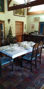 a dining room table with a white tablecloth and chairs at Landhaus in Santo Antônio do Pinhal