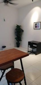 a table and two chairs in a room with a plant at M City Jalan Ampang KL in Kuala Lumpur
