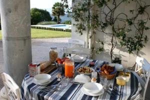a table with a blue and white striped table cloth at Chateau Mont Joly in Gan