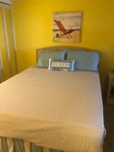 a bed in a bedroom with a sign on it at Beach Colony Ocean Front Executive Suite in Myrtle Beach
