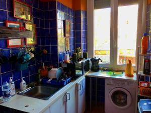 a kitchen with a sink and a washing machine at Comics Guesthouse Hostel in Rome +57 photos