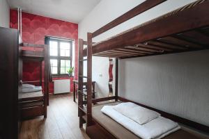 a room with two bunk beds and a window at MoHo E Hostel in Wrocław