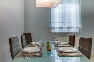 a dining room with a glass table and chairs at House Baumgarten in Mali Lošinj