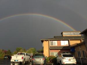 a rainbow in the sky over a parking lot at Travelodge by Wyndham, Newberg in Newberg