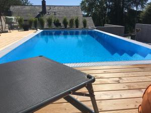 a blue swimming pool with a bench next to it at Chalet Breitnauschön in Breitnau