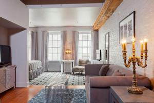 a living room with a couch and a tv at Bluegreen Vacations Club La Pension in New Orleans