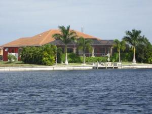 a house on the shore of a body of water at Villa Princess in Cape Coral