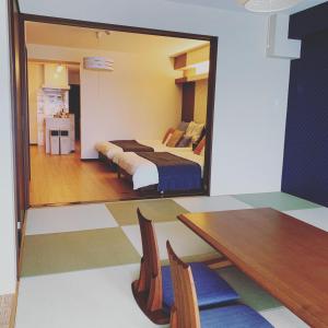 En eller flere senger på et rom på guest house Sakura