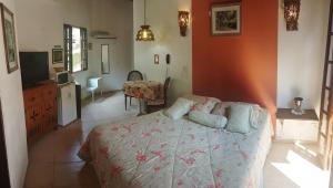 a bedroom with a bed and a television in it at Vila São Pedro in Ilhabela