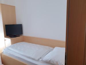 Postel nebo postele na pokoji v ubytování Hotel Garni Herz