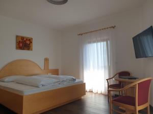 Postel nebo postele na pokoji v ubytování Hotel Garni Herz