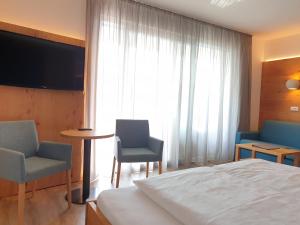 Postel nebo postele na pokoji v ubytování Hotel Garni Herz
