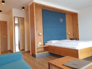 Postel nebo postele na pokoji v ubytování Hotel Garni Herz