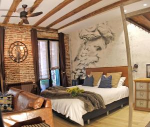 a bedroom with a bed with a painting on the wall at Old Town apartment in San Sebastián