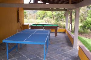 a blue ping pong table on a patio at Pousada Ranchico in Brumadinho