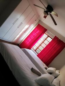 a bedroom with two beds and a window at Tumi's Home away- 3 Bedroom in Witbank